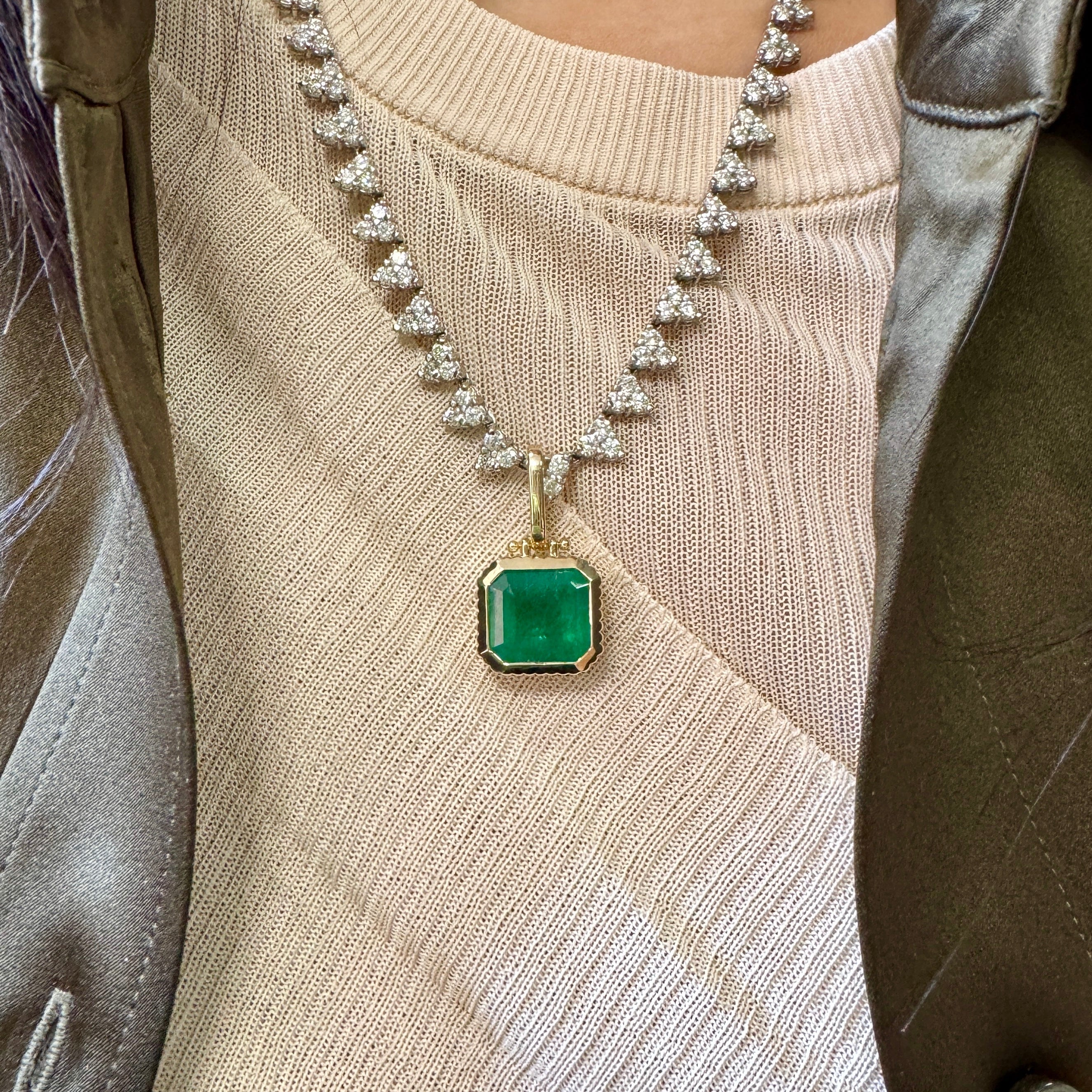Necklace with a green pendant worn by a person