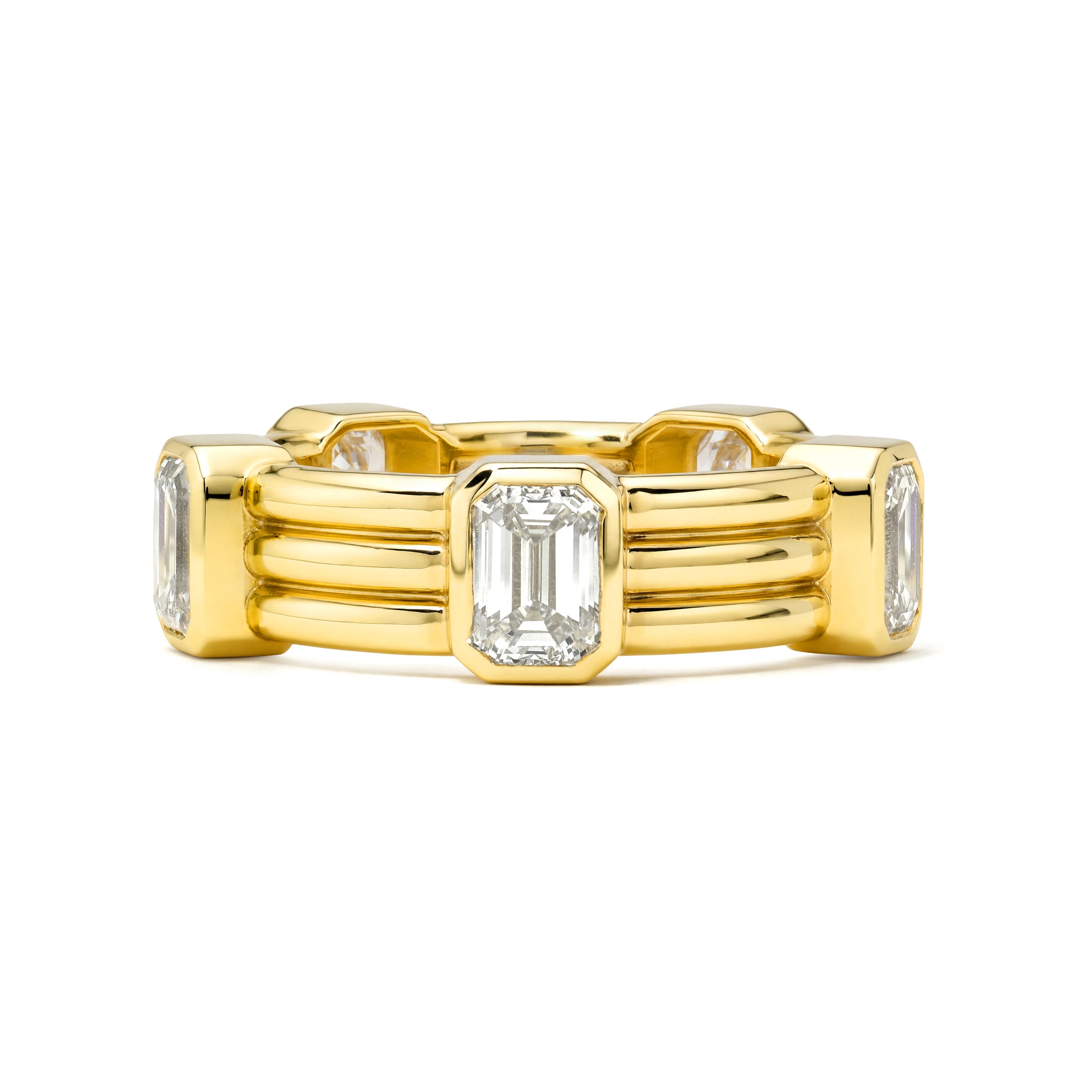 Gold ring with emerald-cut diamonds on a white background