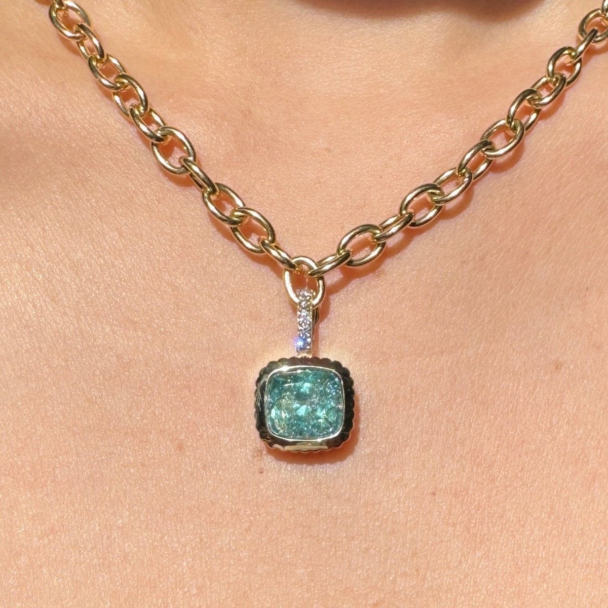 old pendant with a blueish green vanadium beryl with a diamond bail