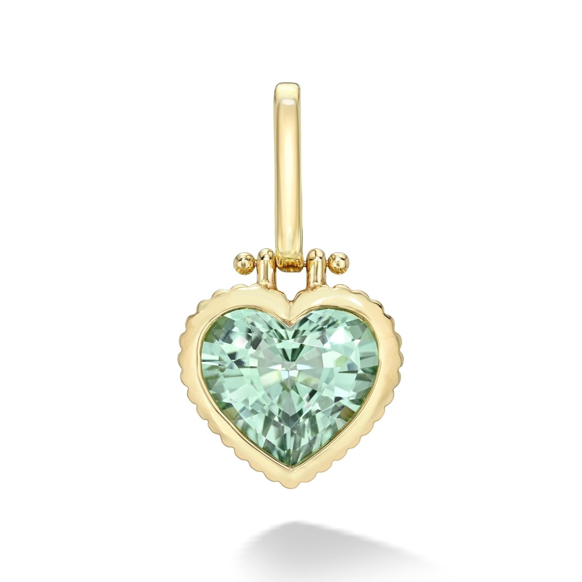Heart-shaped pendant with green gemstone and gold frame on a white background