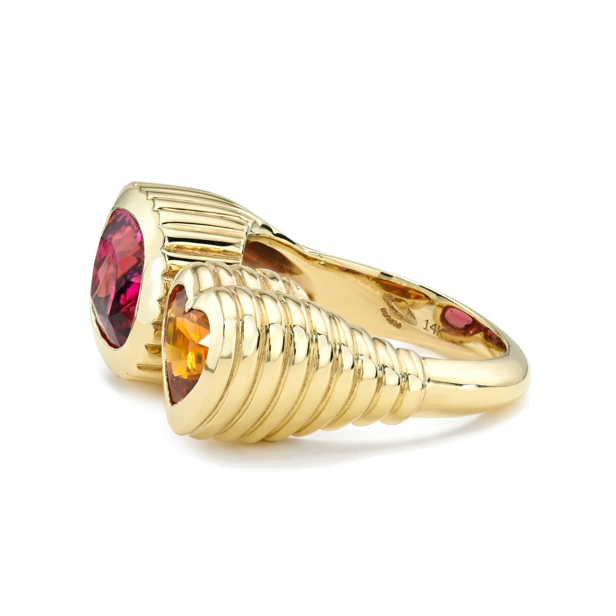 Gold ring with red and orange gemstones on a white background